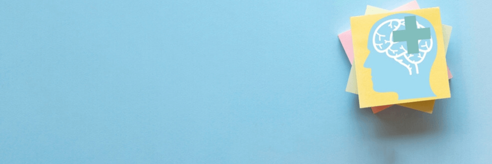 Sticky note with human head and green cross icon, representing health and wellness.